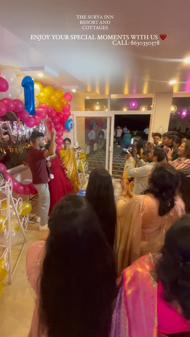 Birthday celebration with balloon arch