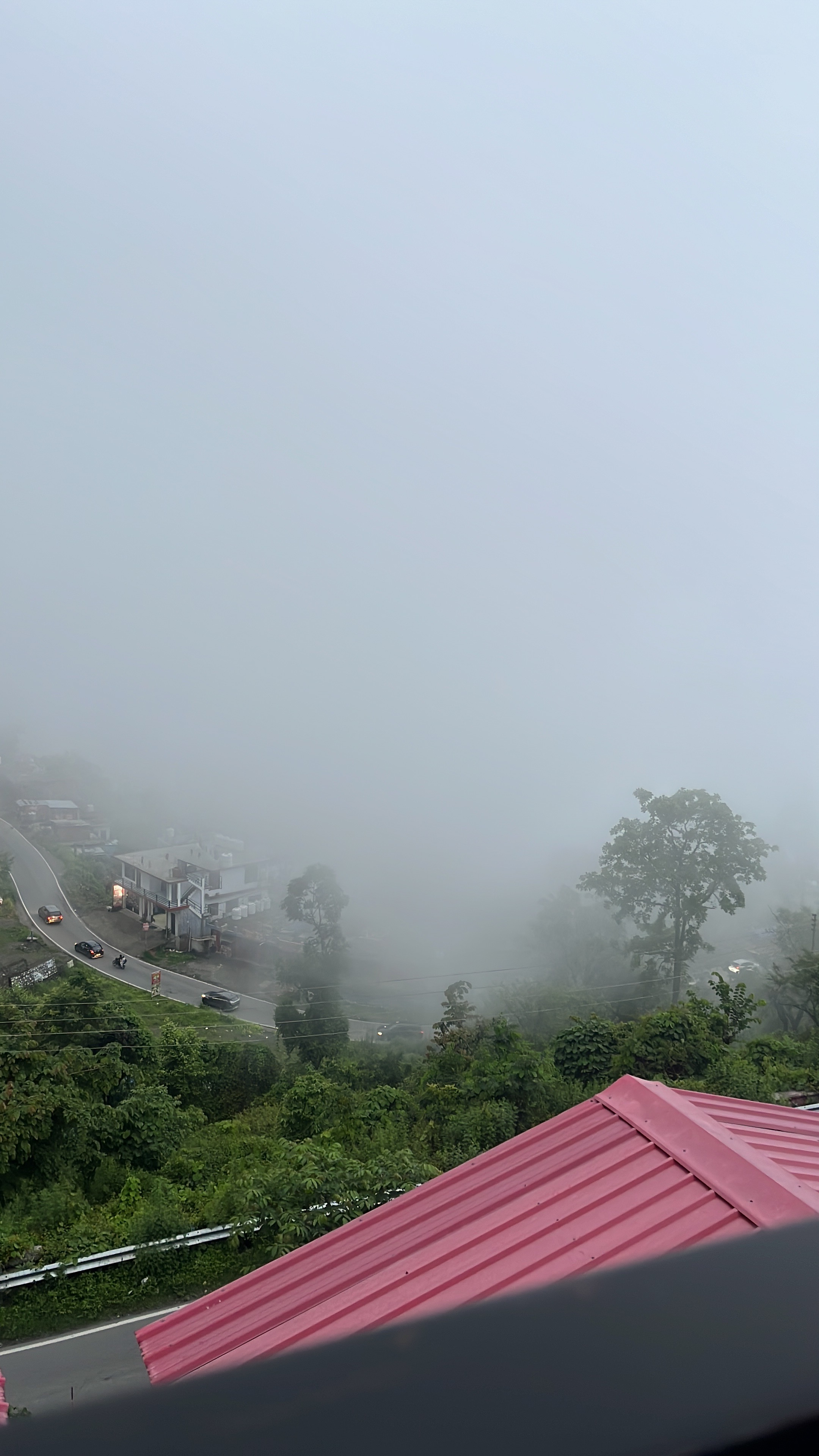 Misty fog rolling over the Bhimtal valley viewed from Surya Inn